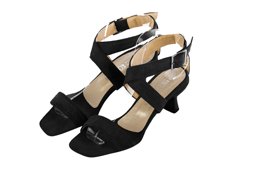 Matt black elegant sandals with cross straps across the instep, fully open. Square toe. Medium spool heels.